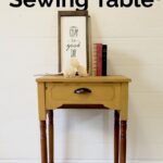 yellow painted sewing table with stained legs
