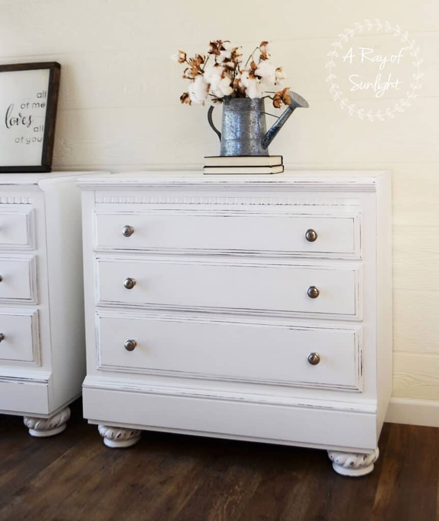 white painted nightstands with distressing and nickel knobs