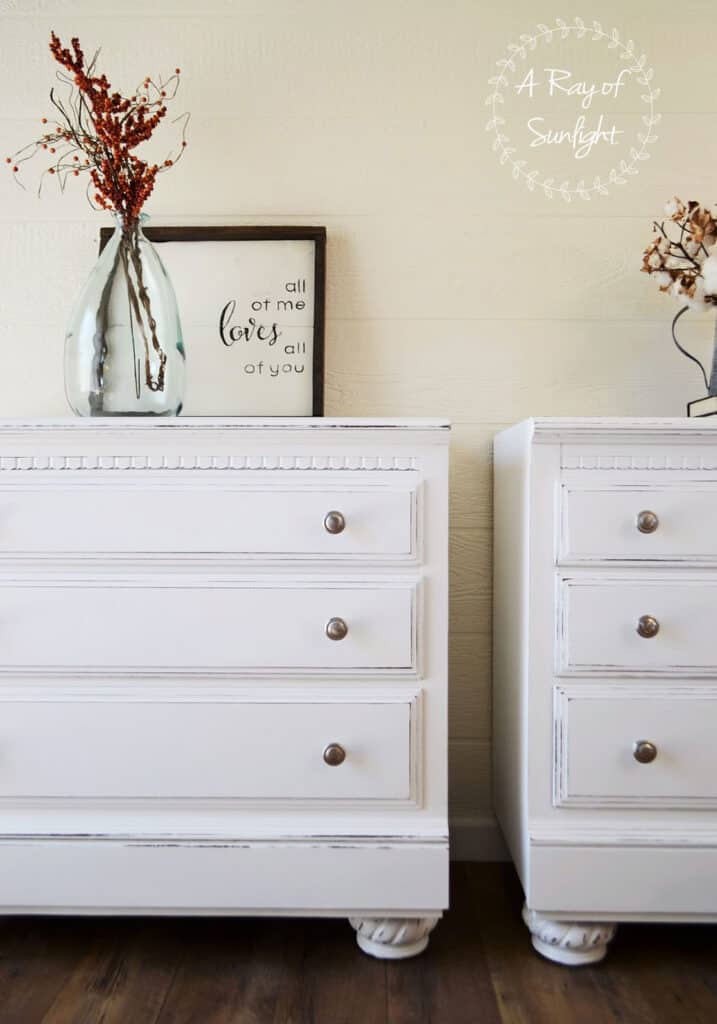 white painted nightstands with distressing and nickel knobs