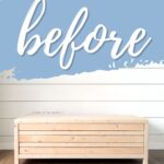 Light wood coffee table against white shiplap wall