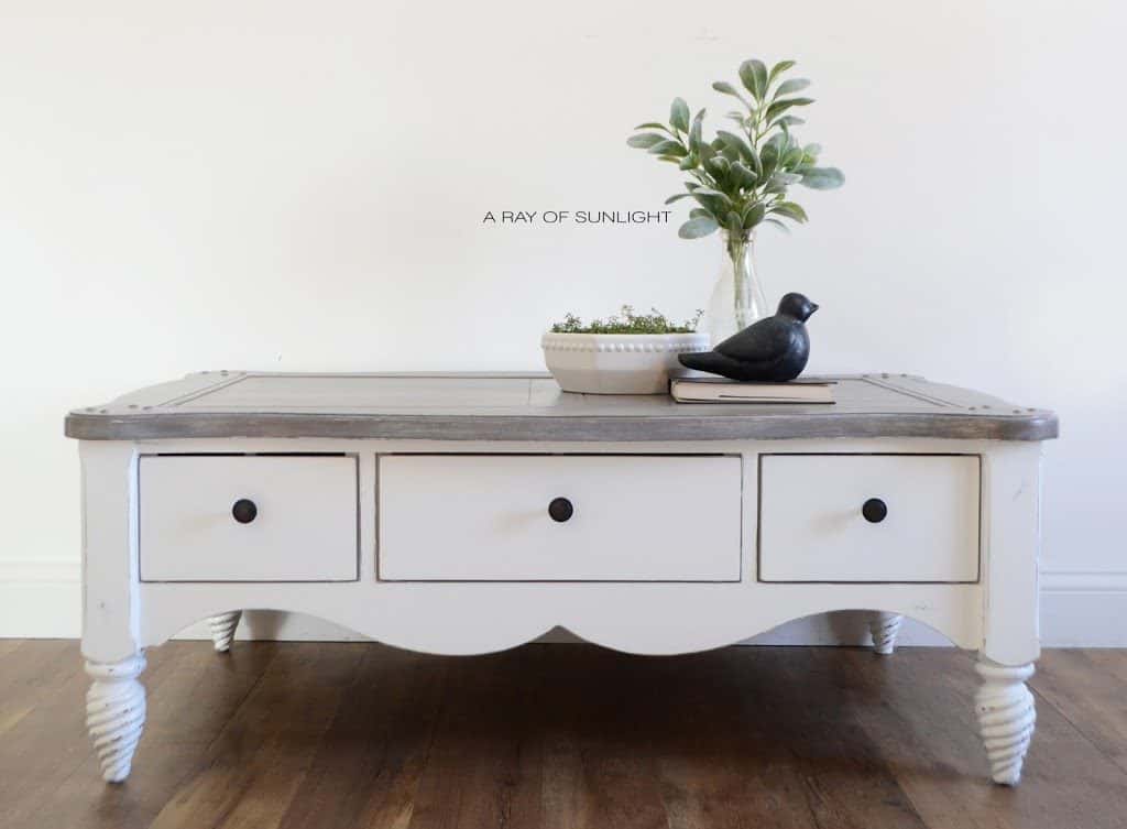 Front view of white painted coffee table with a painted weathered wood top