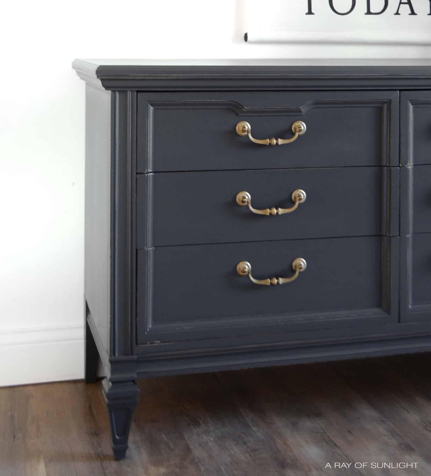 closeup of grey chalk painted furniture with gold hardware
