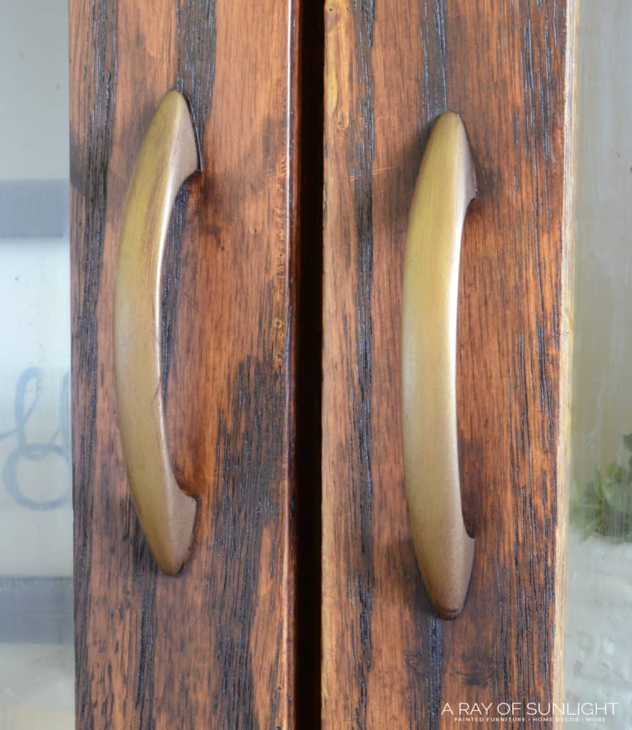 Close up view of hardware pulls on a farmhouse cabinet.