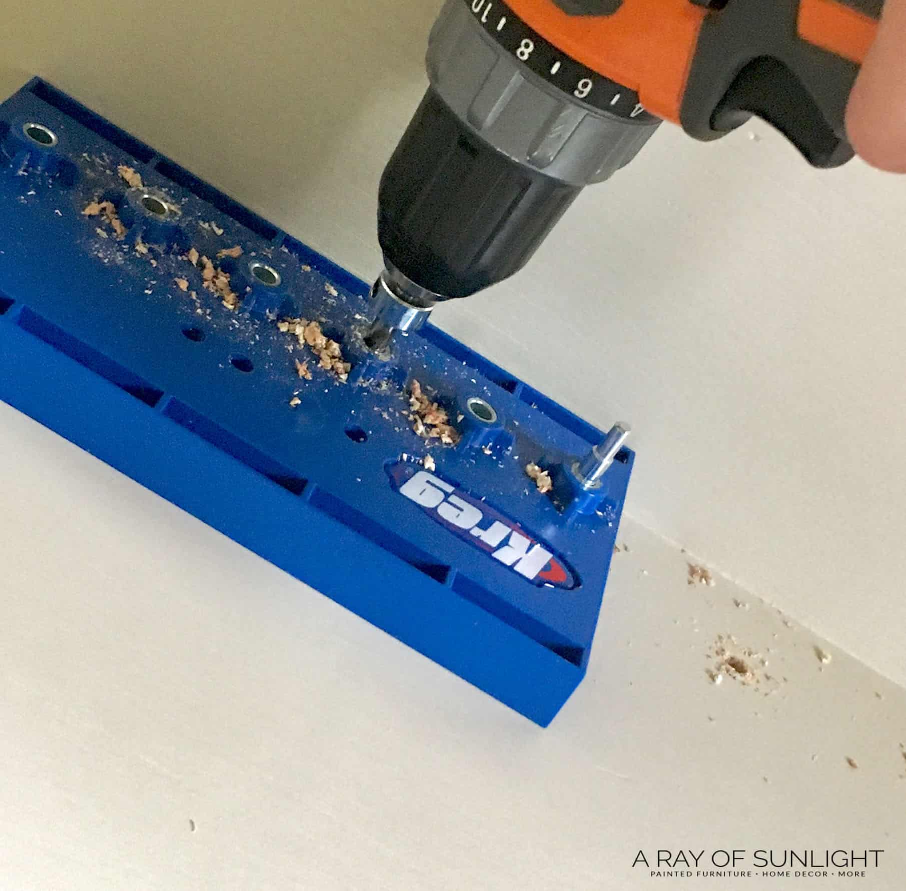 drilling holes with a kreg shelf pin jig inside the cabinet