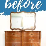 A wooden French provincial dresser with a large mirror and gold handles