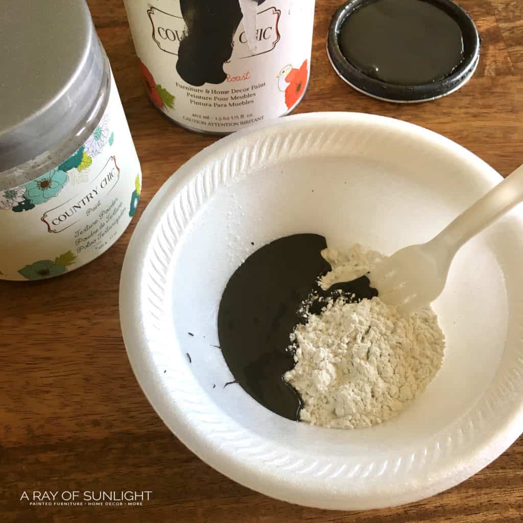 Using a fork to mix texture powder and paint in a bowl