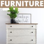 White dresser with raised stenciling, plant, and framed sign on top; text: DIY raised stencil on furniture.