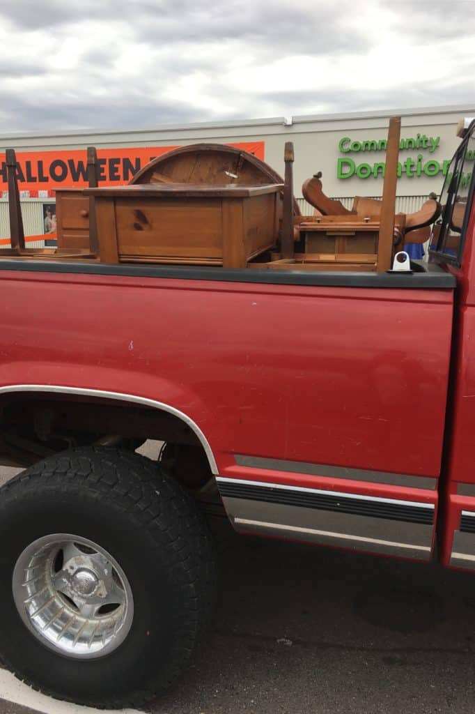 the back of a pickup filled with furniture