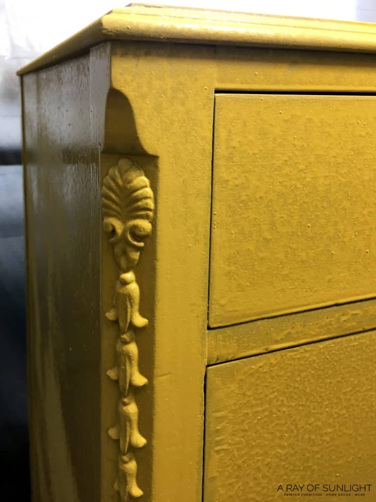dresser sprayed with yellow milk paint