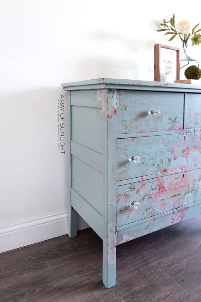 Side view of teal dresser with floral transfer
