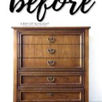 A scratched brown wooden dresser before painting