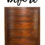 dark vintage wooden dresser with five drawers and metal handles