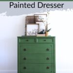 emerald green painted dresser with black round knobs