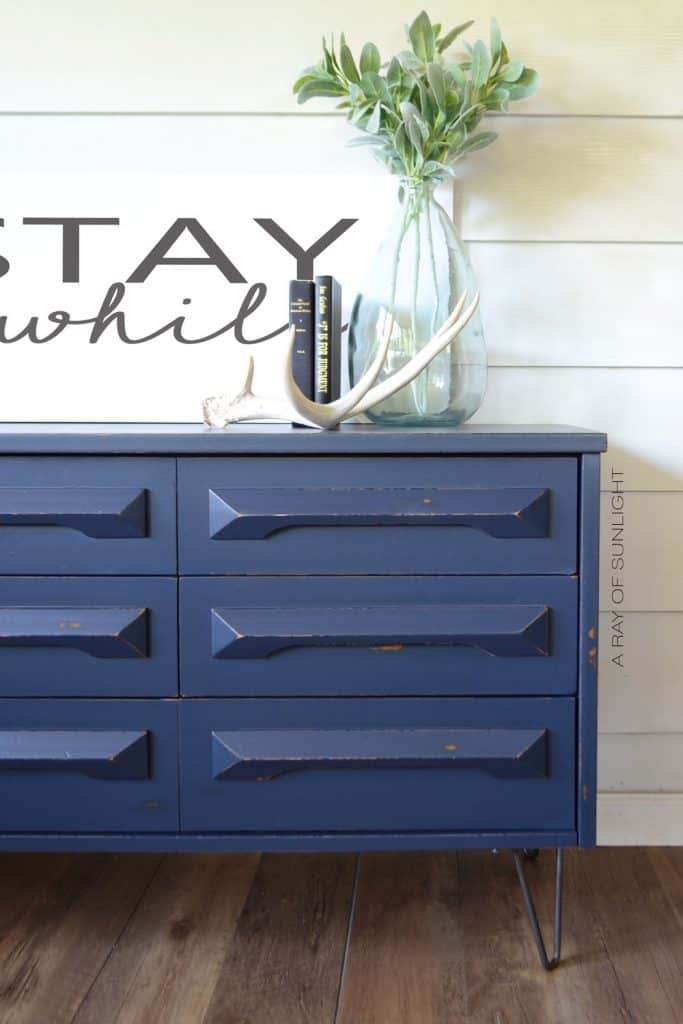 dark blue painted dresser with close up view of new hairpin legs