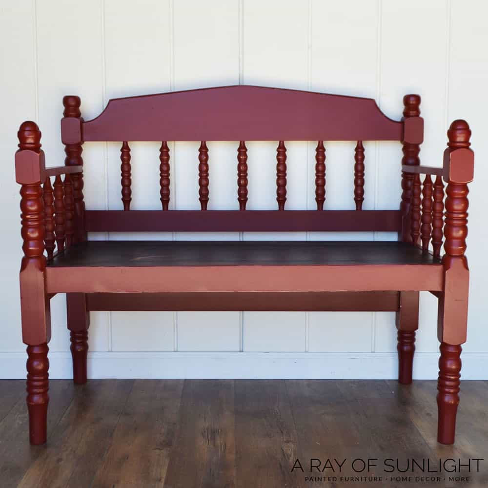 bench made from headboard and footboard painted rustic red for a porch bench