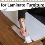 Person painting white primer on a wooden table with text about bonding primer for laminate furniture.