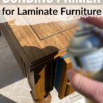 Hand spraying primer on a wooden piece of laminate furniture; text says Best Bonding Primer for Laminate Furniture.