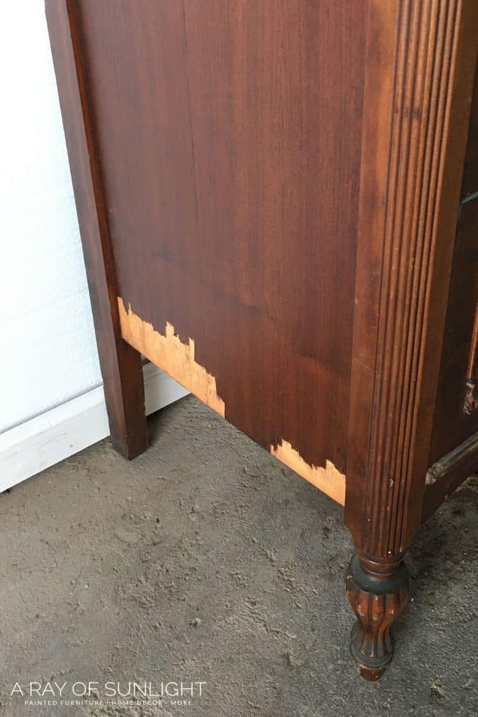 side view of chipping veneer on a dresser