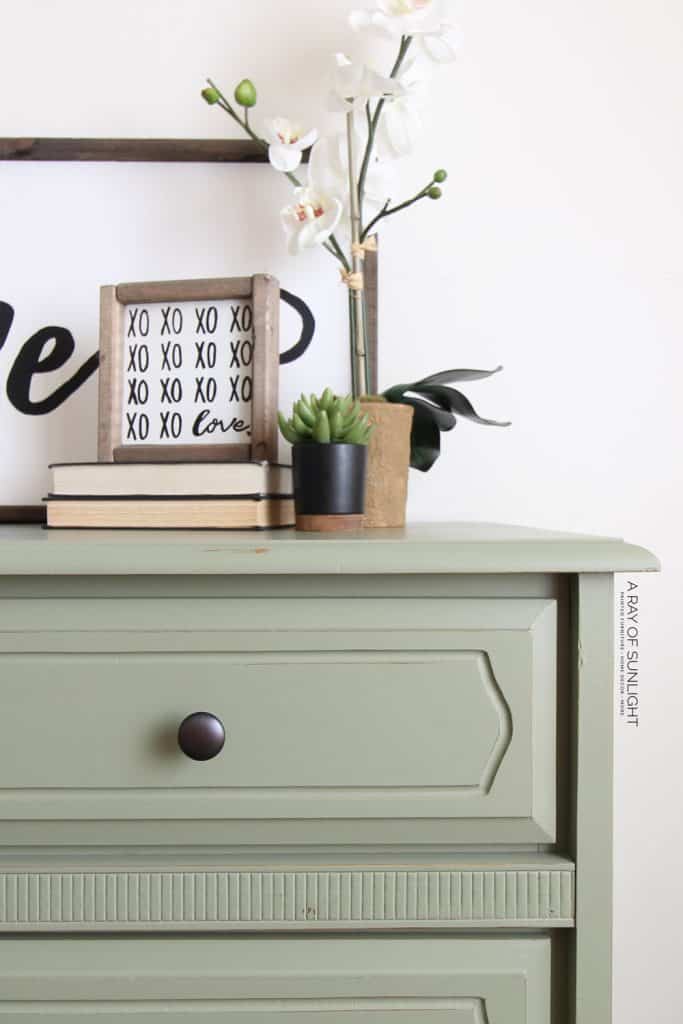 close up photo of olive green painted dresser