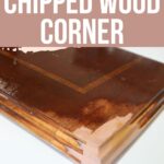 Close-up of a wooden furniture corner with chipped wood, showing repair in progress.