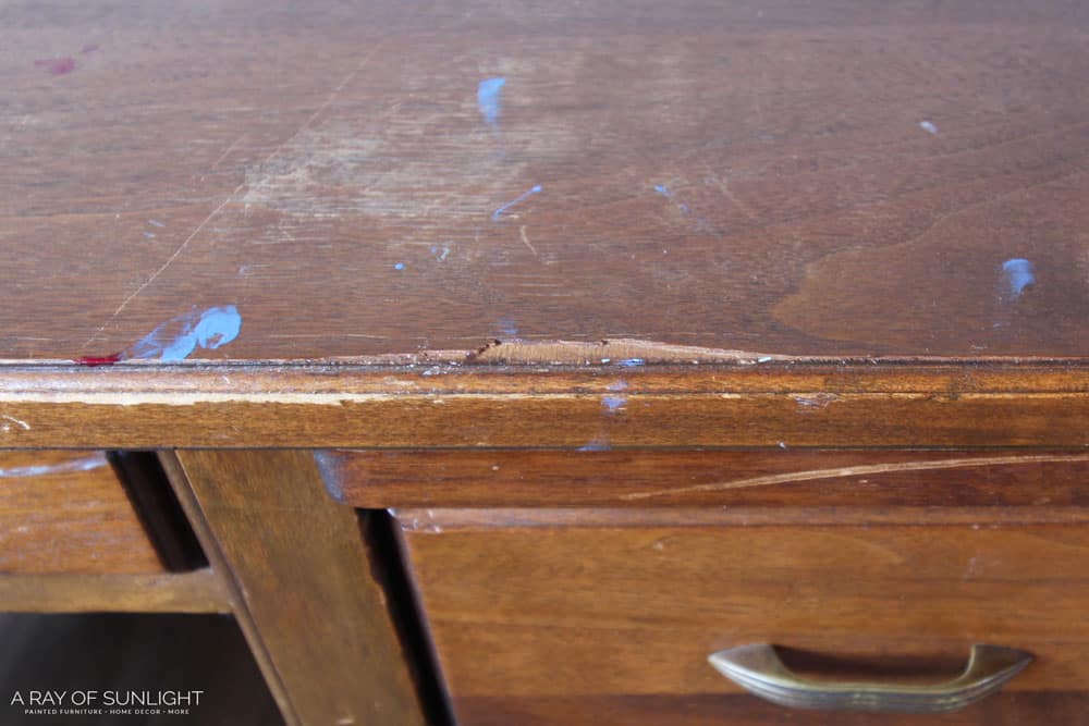 chipped wood veneer on an antique desk