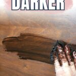 Gloved hand applying dark wood stain to a wooden surface with text How to Stain Wood Darker.