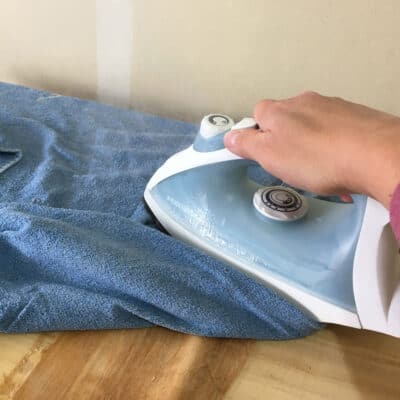 hot iron on wet towel to loosen veneer