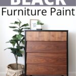 A wooden dresser with black trim beside a potted plant, labeled The Best Black Furniture Paint.