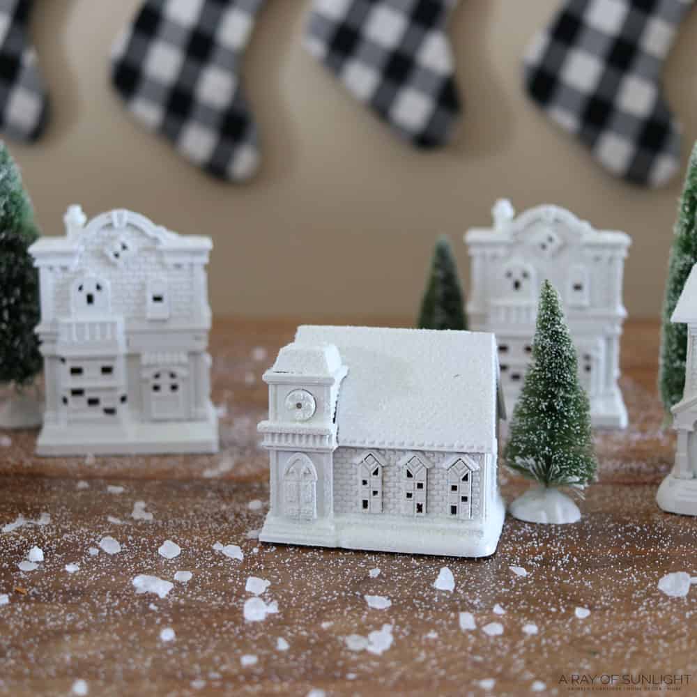 White painted christmas village with bottle brush trees