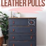 A navy dresser with brown leather pulls, labeled “DIY LEATHER PULLS” in bold letters above.