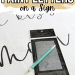 A pencil and graphite paper on a sign template with the text How to Paint Letters on a Sign.