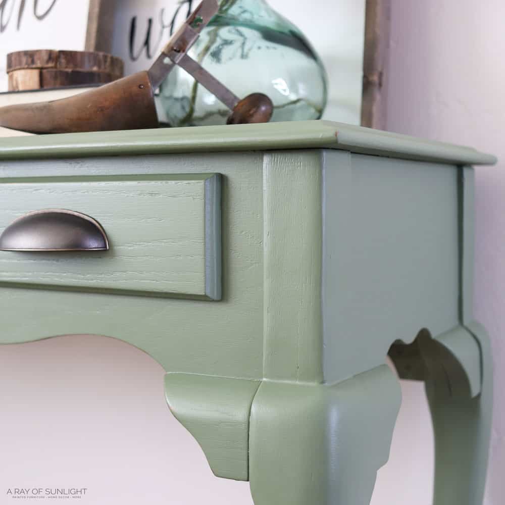 close view of a green painted sofa table