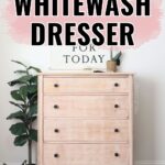A whitewashed dresser with black knobs, plants, and wall art in a bright, modern room. Text reads DIY Whitewash Dresser.