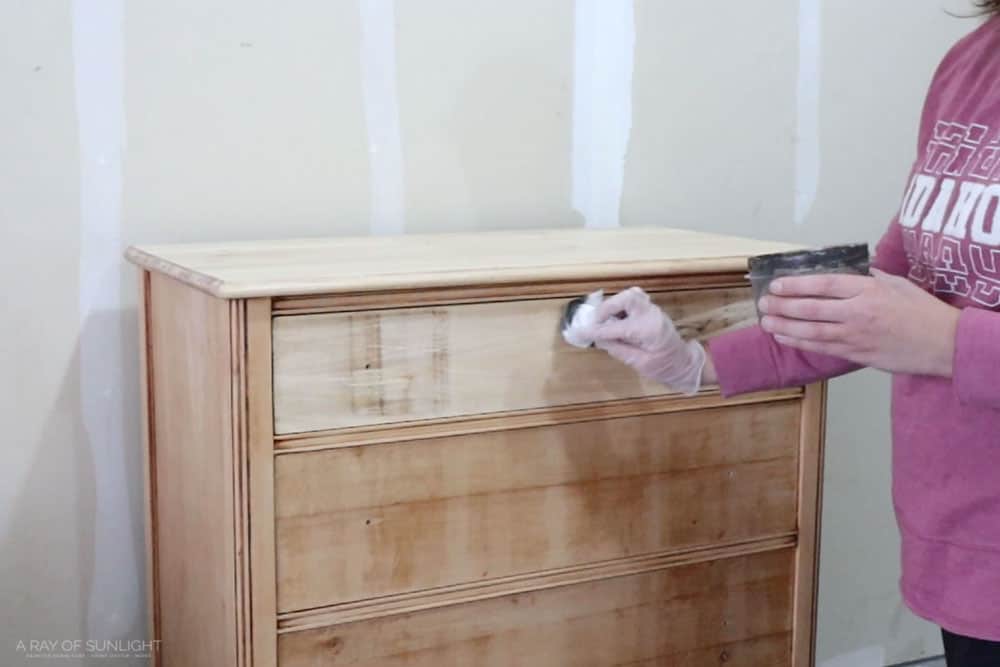 wiping brown waterbased stain onto the top drawer