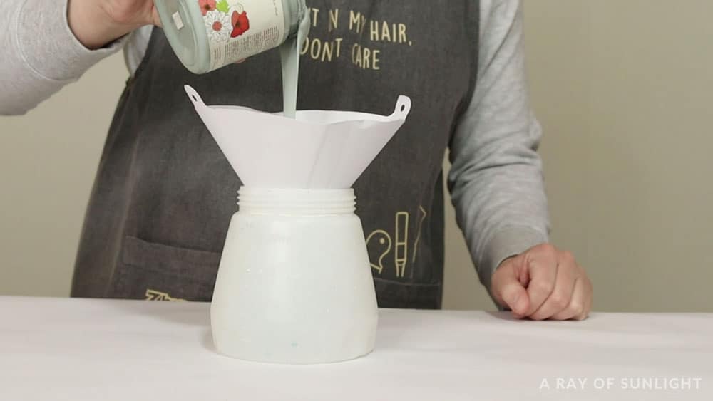 pouring chalk paint into wagner paint sprayer with paint filter