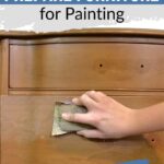 A hand sanding a wooden dresser, with text about preparing furniture for painting.