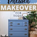 Blue chalk-painted dresser with bronze handles, styled with decor, plant, and a typewriter beside it.