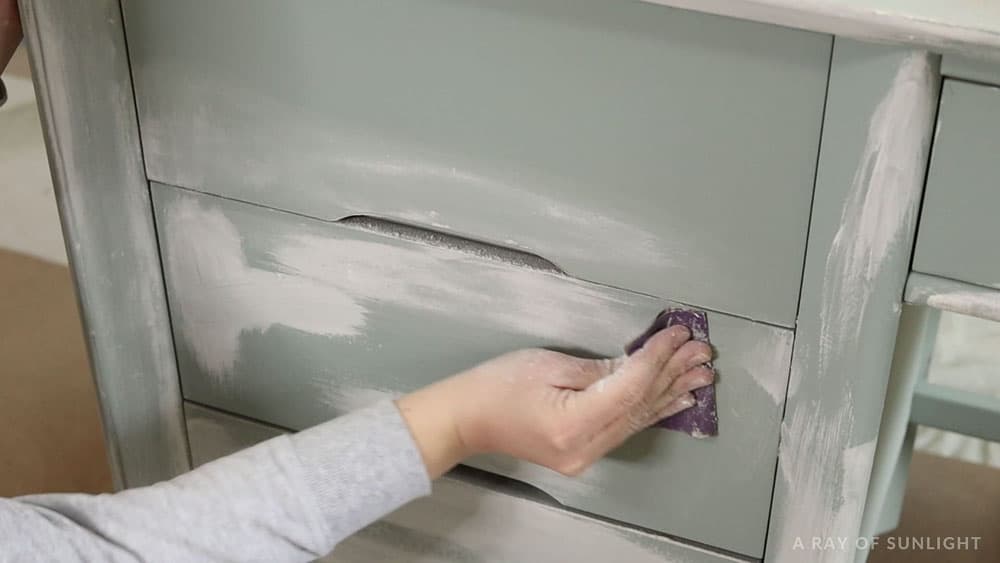 sanding the spackling off of the desk