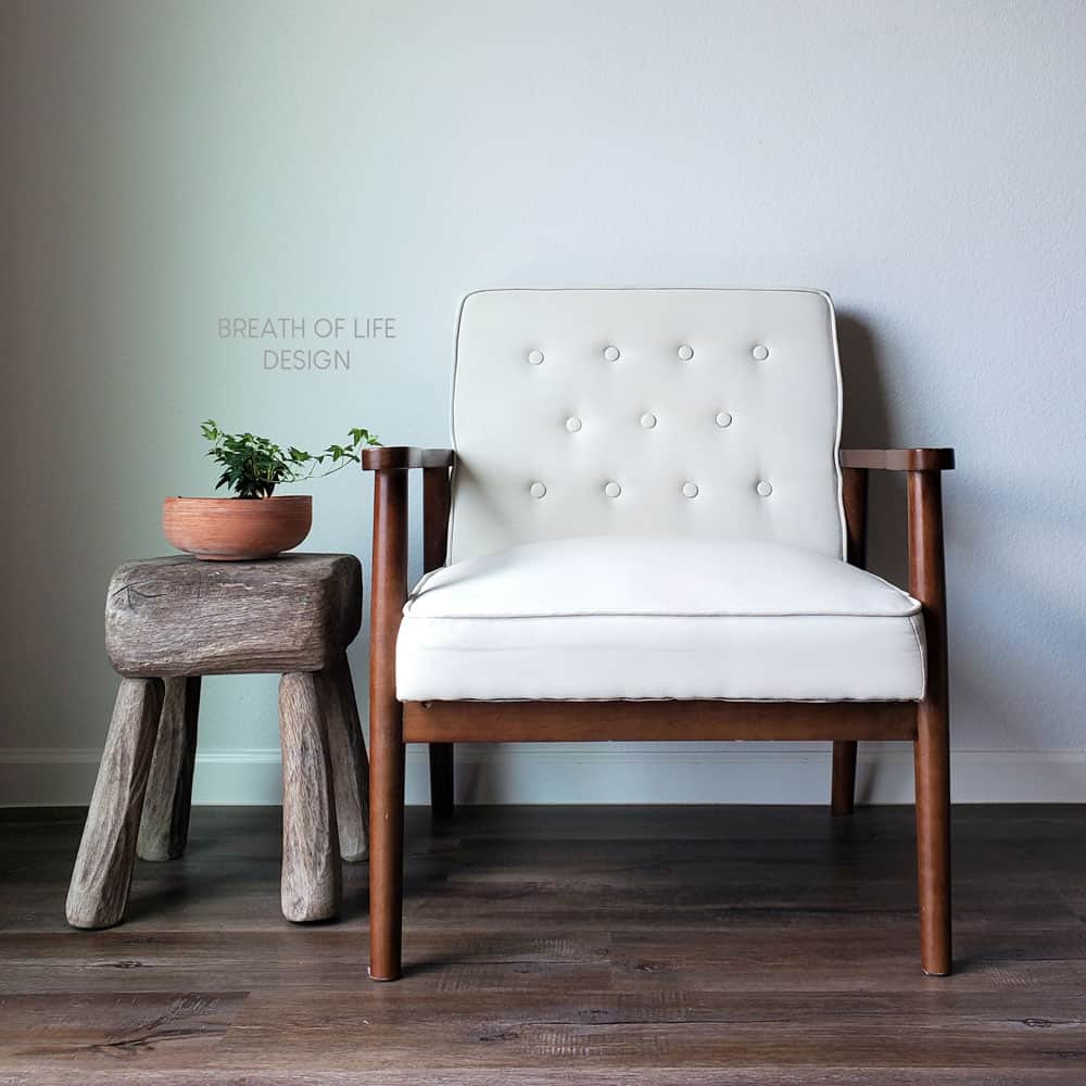 Full shot of fabric chair painted with chalk paint