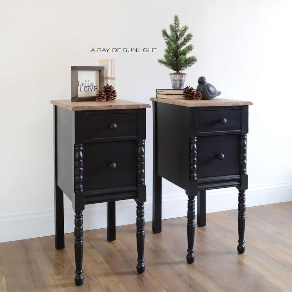 vanity turned into black painted farmhouse style nightstands with black knobs and wood tops