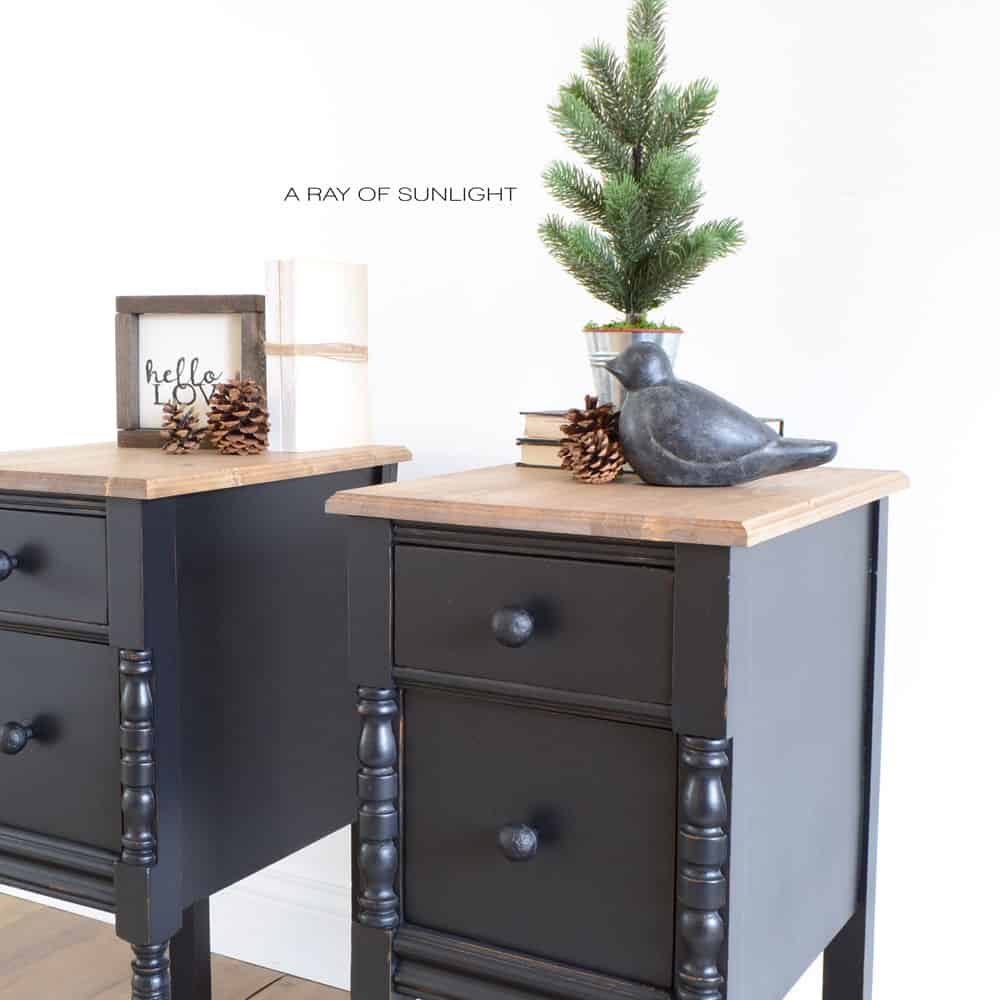 both of the black painted nightstands next to each other decorated for christmas