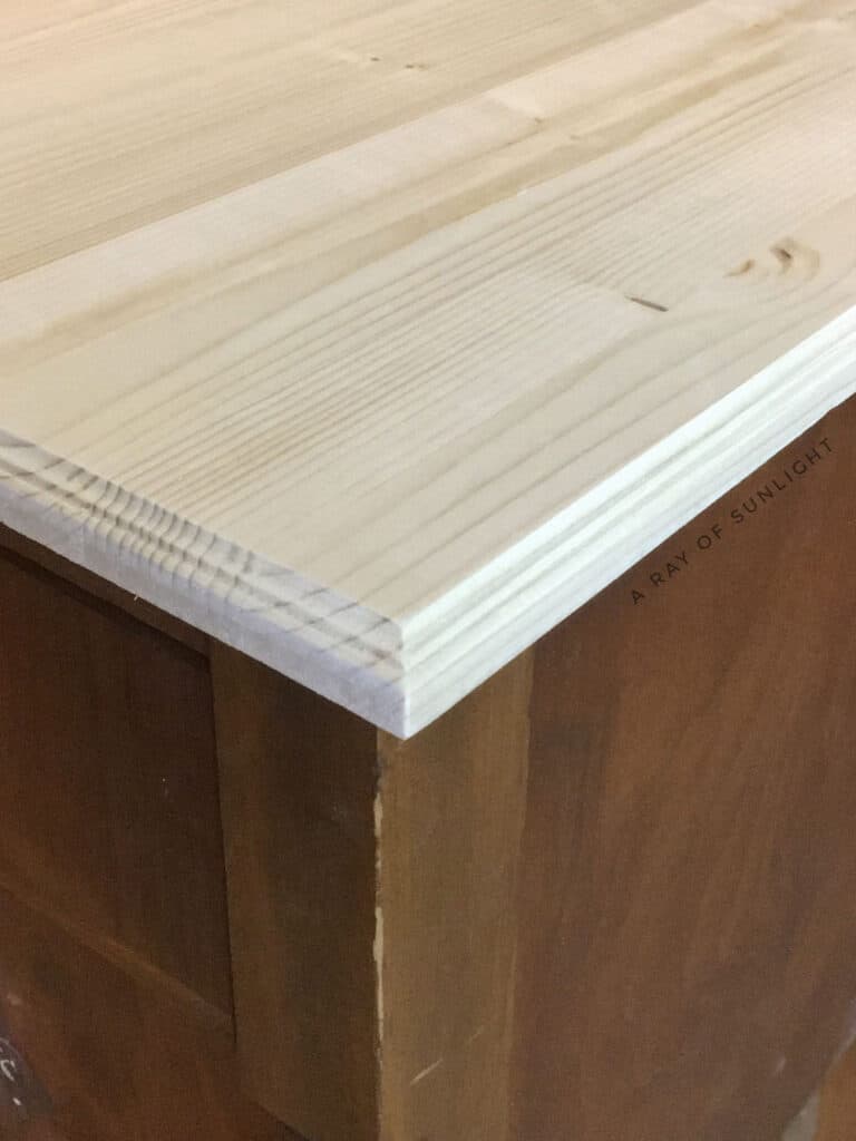 closeup shot of the laminated common board cut and routered to make a new wood top for the nightstands