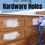 A person sands a wooden dresser with filled hardware holes