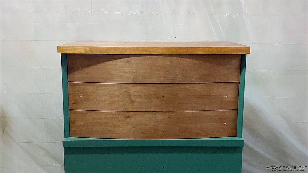 Green painted dresser with natural wood top two drawers and natural wood on the top.
