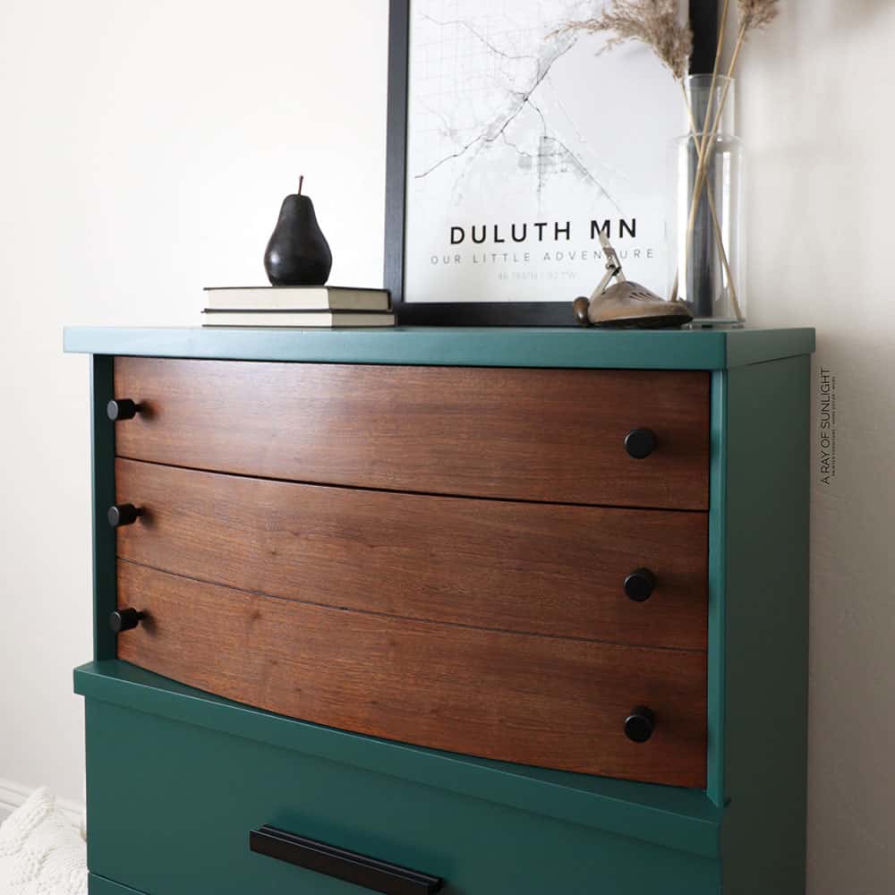 Green painted dresser with stained top drawers and black knobs.