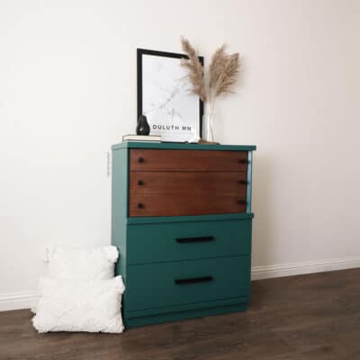 Green painted dresser with stained wood drawers and top.