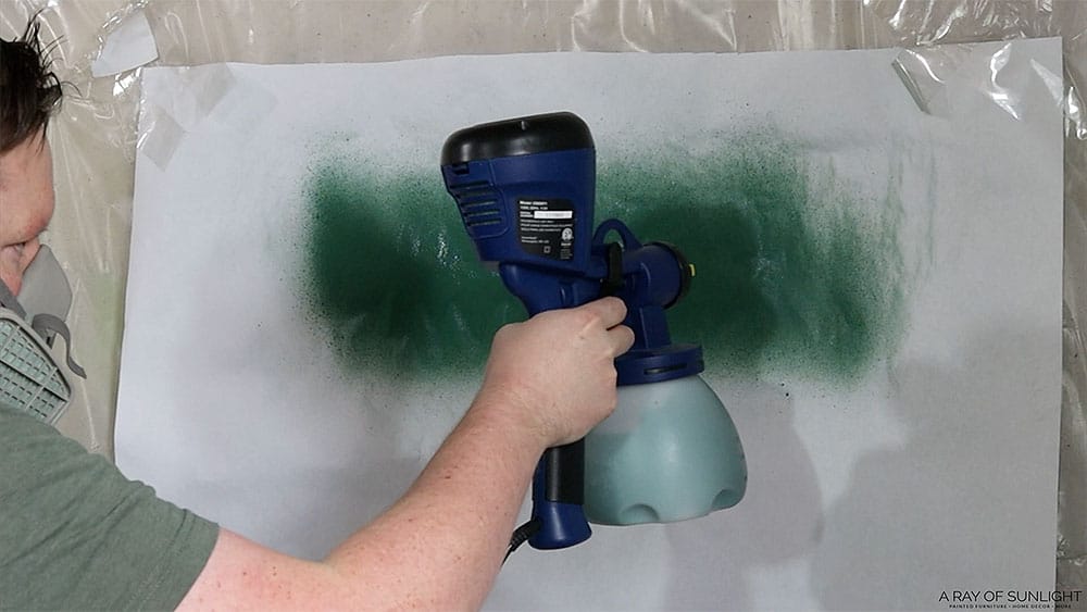 Testing how much paint sprays out of the paint sprayer on a piece of paper.