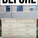A plain light wood dresser with eight drawers sits on a dolly