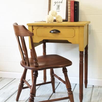 upcycled sewing machine table into a desk and painted yellow