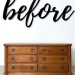 Wooden dresser with six drawers, in front of a white wall with the word before written in large script.